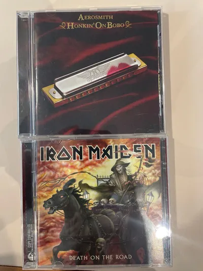 Cd's Iron Maiden y Aerosmith